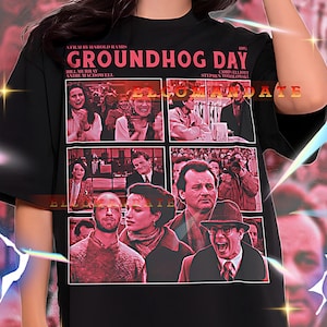May include: Black unisex t-shirt with a Groundhog Day movie poster design. The design includes the movie title, cast names, and film stills. The shirt is a 2XL size.