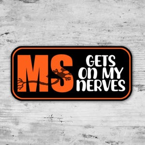 May include: A rectangular sticker with a black border and background. The sticker features the orange letters "MS" with a brown neuron graphic, and the white text "GETS ON MY NERVES".