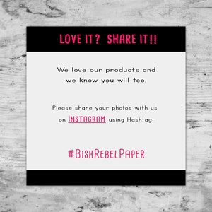 May include: Black and white sign with the text "LOVE IT? SHARE IT!!" in pink. The sign also includes the text "We love our products and we know you will too. Please share your photos with us on INSTAGRAM using Hashtag: #BISHREBELPAPER"