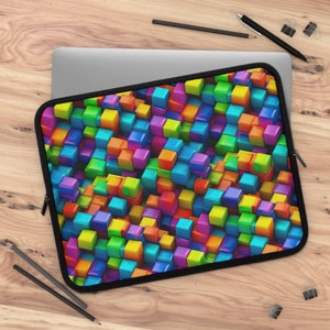 May include: A laptop sleeve with a colorful abstract design featuring a pattern of 3D cubes in various shades of red, orange, yellow, green, blue, purple, and pink.
