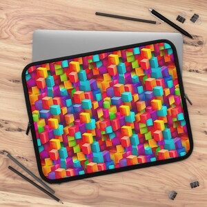 May include: A colorful laptop sleeve with a pattern of 3D cubes in shades of red, orange, yellow, green, blue, purple, and pink.
