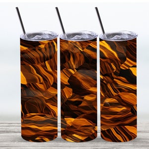 May include: Three stainless steel tumblers with a swirling pattern of brown and gold. The tumblers have lids and straws.