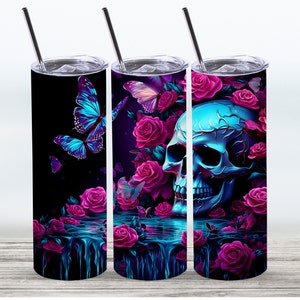 May include: Three stainless steel tumblers with different designs. The first tumbler features a blue and purple butterfly on a black background. The second tumbler features a blue skull with pink roses and butterflies on a black background. The third tumbler features a blue skull with pink roses on a black background.