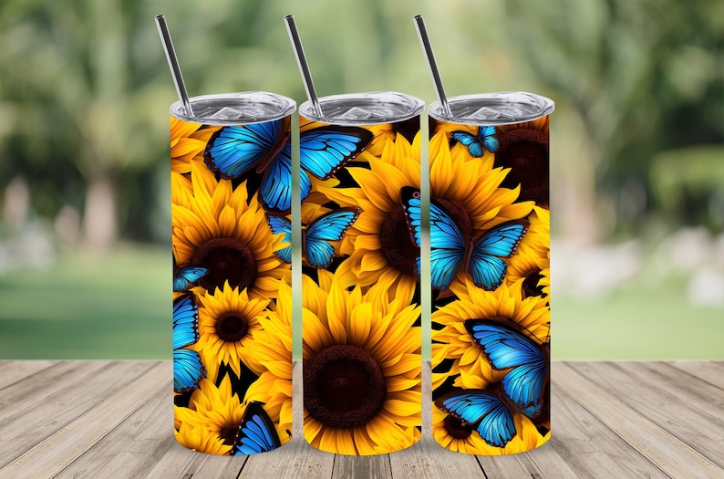 May include: Three stainless steel tumblers with a design of blue butterflies and yellow sunflowers.