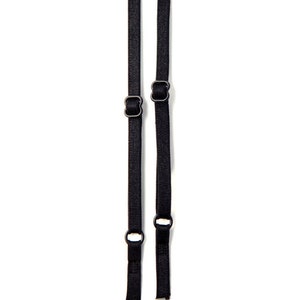 May include: Two black adjustable bra straps with metal hardware.
