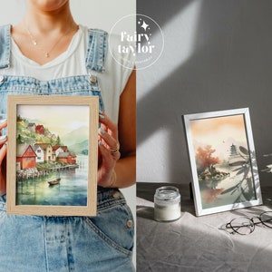 May include: Two watercolour paintings in wooden frames. The first painting depicts a small village with red houses on a waterfront. The second painting shows a pagoda in a landscape with a red tree.