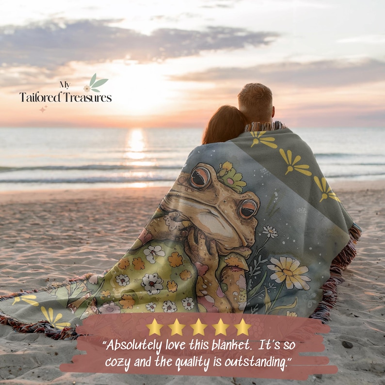 May include: A woven blanket featuring a whimsical frog illustration in shades of green, tan, and yellow. The blanket has a fringed edge and is draped over two people on a beach. The text "My Tailored Treasures" is visible in the upper left corner.