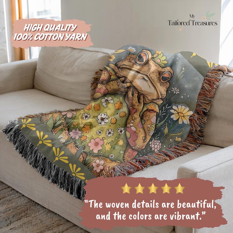 May include: A woven throw blanket featuring a whimsical frog design. The blanket showcases a frog wearing a floral dress, surrounded by flowers in shades of green, yellow, and pink. The text "HIGH QUALITY 100% COTTON YARN" is visible. The blanket is draped over a beige sofa.