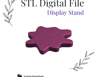 May include: A purple 3D printed display stand with a wavy, irregular shape. The stand has a slot in the center for displaying an object. The text "STL Digital File Display Stand" is visible above the stand.
