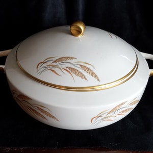 May include: White ceramic serving bowl with a gold rim and lid. The bowl has a design of brown and gold wheat stalks.