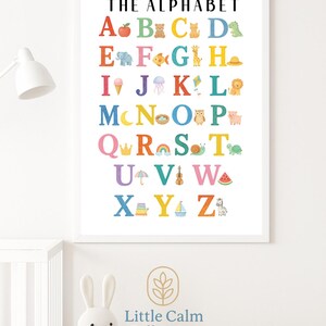 May include: A colorful alphabet chart with illustrations for each letter. The letters are in a rainbow of colors and the illustrations include a red apple, a brown bear, a yellow cat, a green dinosaur, a blue elephant, a yellow fish, a green giraffe, a pink hat, an ice cream cone, a purple jellyfish, a red kite, a brown lion, a yellow moon, a brown nest, an orange owl, a pink pig, a blue crown, a red rainbow, a green snail, a brown turtle, a purple umbrella, a blue violin, a pink watermelon, a blue stack of books, a yellow sailboat, and a black and white zebra.