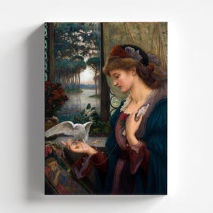May include: A woman in a blue dress with a white dove perched on her hand. She is holding a small object in her other hand. The woman is standing in front of a window with a view of a lake and trees.