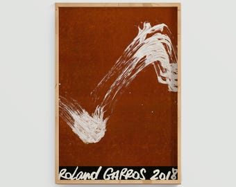 May include: Framed art print featuring a bold white brushstroke design on a reddish-brown background. The artwork is set within a natural wood frame. The text "Roland GARROS 2018" is printed in white on a black band at the bottom.