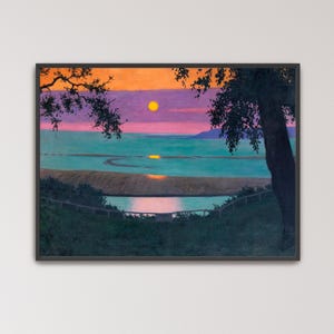 May include: A framed landscape painting depicting a sunset over a body of water. The sky features vibrant orange and purple hues with a bright yellow sun. A dark tree silhouette frames the right side, while a fence borders the foreground grass.