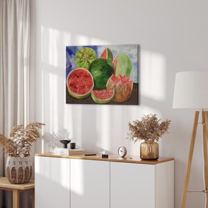 May include: A watercolor painting of watermelons. The painting features whole and sliced watermelons in shades of green and red against a blue and white background. The painting is displayed on a white wall.