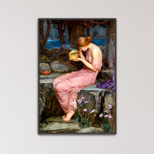 May include: A framed print of a classical painting. A woman in a flowing pink dress sits on a stone wall, holding a small golden box. The background features a forest, water, and a small red cup.