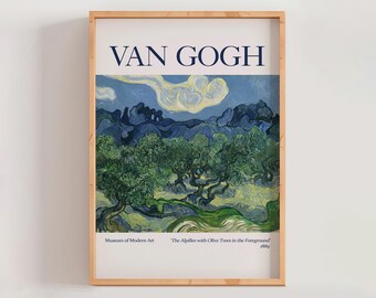 May include: A framed print of Van Gogh's "The Alpilles with Olive Trees in the Foreground" from 1889. The artwork features olive trees under a blue sky with white clouds. The print is in a light brown wooden frame. The text "VAN GOGH" is at the top.
