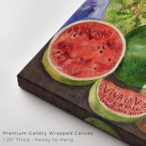 May include: A gallery-wrapped canvas print featuring a vibrant still life of watermelons. The artwork showcases a sliced watermelon with red flesh and black seeds, alongside whole watermelons. The text "VIVA LA VIDA" is visible. The canvas is 1.25 inches thick.