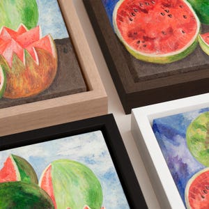 May include: Four framed canvas art pieces featuring watercolor paintings of watermelons. The watermelons are depicted in various states, including whole, sliced, and cut open, with a focus on their red and green colors. The frames are in black, white, brown, and natural wood.
