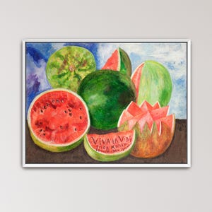 May include: A framed painting of watermelons. The painting features several whole and sliced watermelons in shades of green and red. One slice has the text "VIVA LA VIDA" and the artist's name.