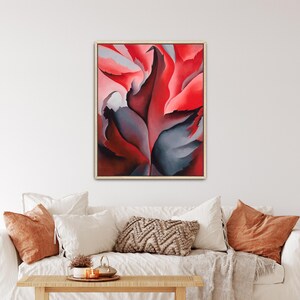 May include: A framed rectangular wall art print featuring an abstract composition of large, flowing organic shapes in vibrant shades of red, deep crimson, and dark charcoal gray, creating a sense of movement and depth within the artwork.