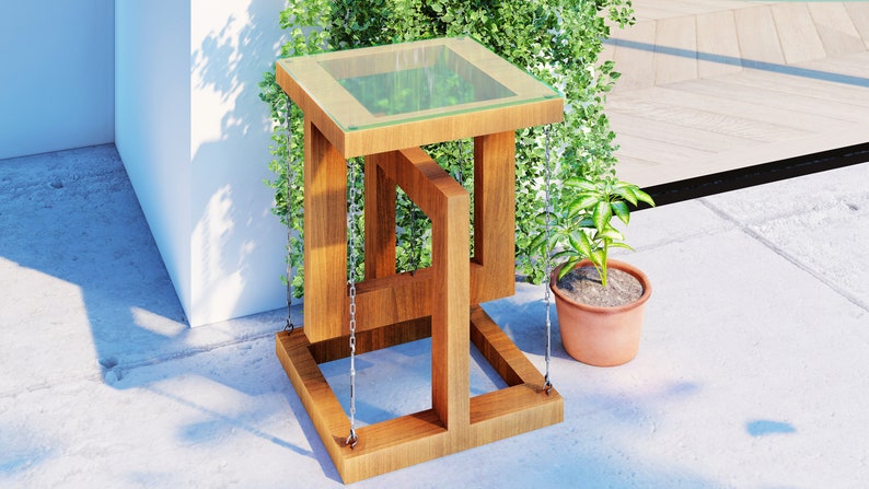 May include: A wooden side table with a glass top and a unique geometric design. The table is suspended by chains and has a natural wood finish.