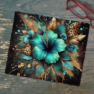May include: A black microfiber cleaning cloth with a colorful floral design. The design features teal and gold hibiscus flowers with leopard print accents.