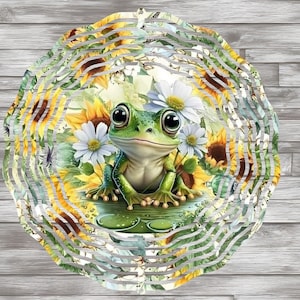 May include: A green frog with a white and yellow sunflower design on a metal wind spinner. The frog is sitting on a green leaf with a water drop design.