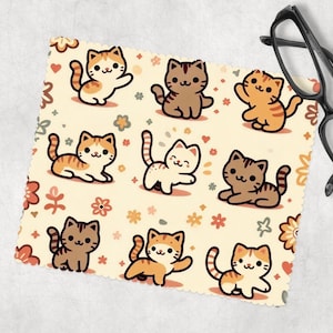 May include: A cream-colored microfiber cleaning cloth with a repeating pattern of orange, brown, and white cartoon cats with flowers and hearts.