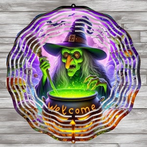 May include: A metal wind spinner featuring a witch stirring a cauldron with a green liquid. The witch is wearing a green dress and a pointed hat. The background is a purple and pink sky with a full moon. The wind spinner has a welcome sign on the bottom.
