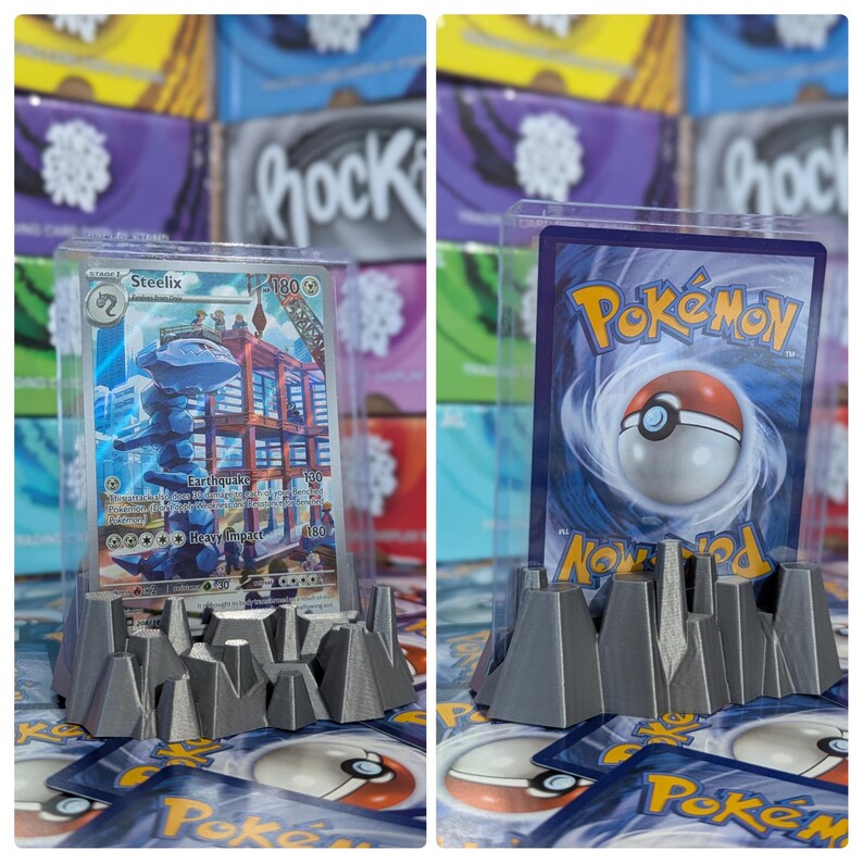 May include: Two Pokemon trading cards displayed on gray 3D printed card holders. The card on the left is a Steelix card with a blue and red background. The card on the right is a Pokemon card with a black and red background. The card holders are shaped like mountains.