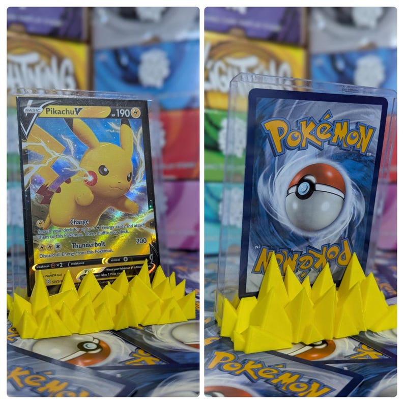 May include: Two Pokemon trading cards displayed on yellow plastic card holders. The card on the left is a Pikachu V card. The card on the right is a Pokemon card with a Pokeball in the center.