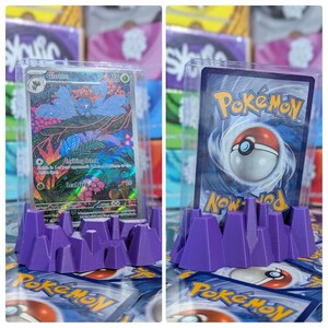 May include: Purple plastic Pokemon card holder with a clear plastic case holding a Gloom Pokemon card. The card has a purple, green, and blue design with the text "Gloom" and "Inviting Scent".