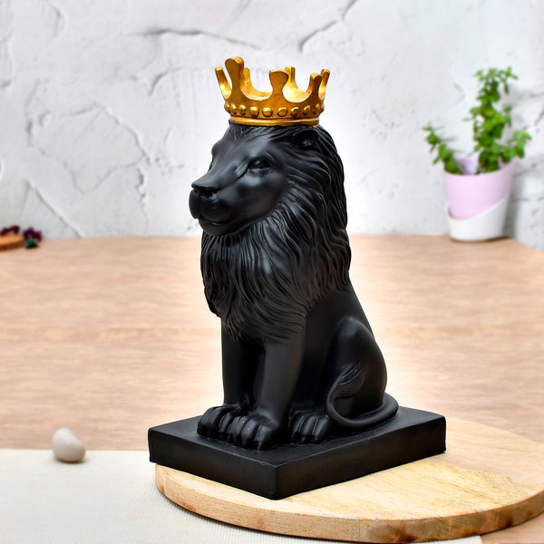 Gold crown Lion Statue with Crown on Wooden Table - Majestic King of the Jungle Sleek Black Lion Sculpture Elegant Ebony Panther Figurine