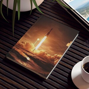 May include: A dark wooden coffee table with a magazine, a book with a rocket launch image, a cup of coffee, and a potted plant. The magazine is titled "TRAVEL MAGAZINE". The book features a rocket launching into the sky.