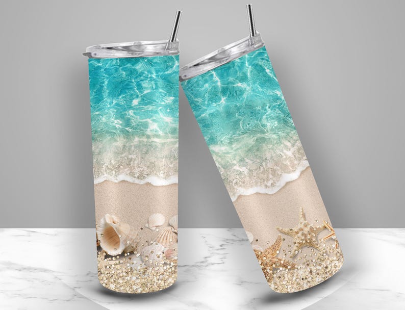 May include: Two stainless steel insulated tumblers with lids and straws. The tumblers feature a beach scene with turquoise water, white waves, sand, seashells, starfish, and glitter.