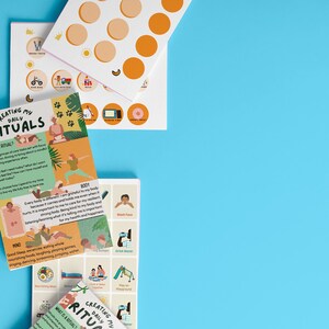 May include: A set of three colourful cards with the title "Creating My Daily Rituals" and illustrations of people engaging in various activities. The cards are on a light blue background.