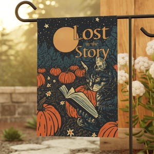 May include: A rectangular garden flag featuring a dark blue night sky with a large yellow moon and stars above a pumpkin patch. A cat sits among the orange pumpkins reading an open book. The text Lost in the Story is printed in gold.