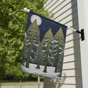 May include: A decorative outdoor flag featuring a nighttime forest scene. The design includes stylized evergreen trees, a full moon, and a snowy ground, all set against a dark blue background. The flag is mounted on a white and black pole.
