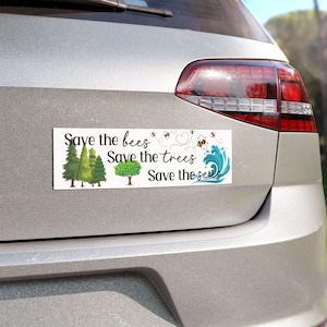 May include: White car bumper sticker with the text "Save the bees, Save the trees, Save the seas". The sticker features a bee, a heart, a tree, and a wave.