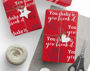 May include: Red wrapping paper with a white firework design and the text "You shake it, you break it".