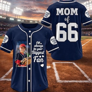 May include: Navy blue baseball jersey with white accents. The front features a photo of a child in a baseball uniform and the text "I'll always be your Biggest Fan." The back displays "MOM of 66."