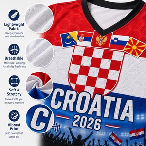 May include: A red, white, and blue V-neck jersey featuring a large Croatian checkerboard crest, the text CROATIA 2026, and a stadium crowd graphic. The fabric has a hexagonal pattern, and the design includes small national flags across the chest.