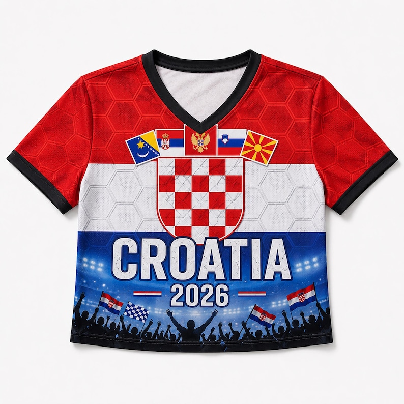 May include: A short-sleeve V-neck shirt featuring a red, white, and blue horizontal pattern with a honeycomb texture. It displays the Croatian coat of arms, various national flags, the text CROATIA 2026, and a silhouette of a cheering crowd.