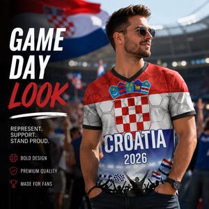 May include: A short-sleeve V-neck t-shirt featuring the red and white checkered Croatian coat of arms, the text "CROATIA 2026", and a graphic of a cheering crowd at the bottom. The shirt has a hexagonal pattern overlay and black trim.