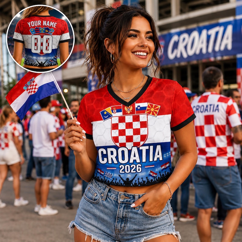 May include: A red, white, and blue V-neck crop top featuring the Croatian coat of arms, the text CROATIA 2026, and a crowd silhouette. The shirt includes a hexagonal pattern and small flags. A small circular inset shows the back with YOUR NAME and 00.
