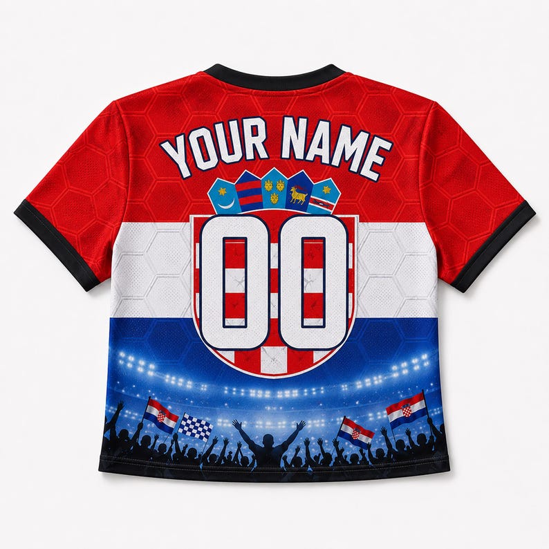 May include: A short-sleeve jersey featuring a red, white, and blue color scheme with a honeycomb pattern. The back displays the text YOUR NAME above a shield with the number 00, and a graphic of a stadium crowd with flags at the bottom hem.