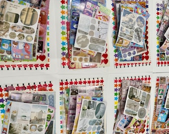 May include: A collection of multiple sticker sheets featuring diverse designs, including photographic landscapes, clouds, beach scenes, and various shapes. The sheets are arranged in a grid, showcasing colorful borders with star and heart patterns.