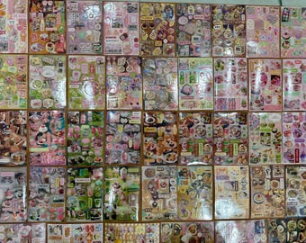 May include: A collection of rectangular sticker sheets featuring a variety of food, drink, and dessert illustrations. The stickers are arranged in a grid pattern, showcasing colorful graphics of cakes, parfaits, beverages, and snacks with Japanese text.