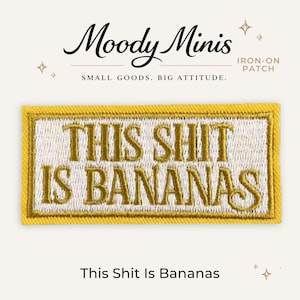 May include: A rectangular iron-on patch with a yellow border and white background. The text 'THIS SHIT IS BANANAS' is embroidered in gold thread in the center. Above the patch, the text 'Moody Minis' and 'IRON-ON PATCH' are visible.